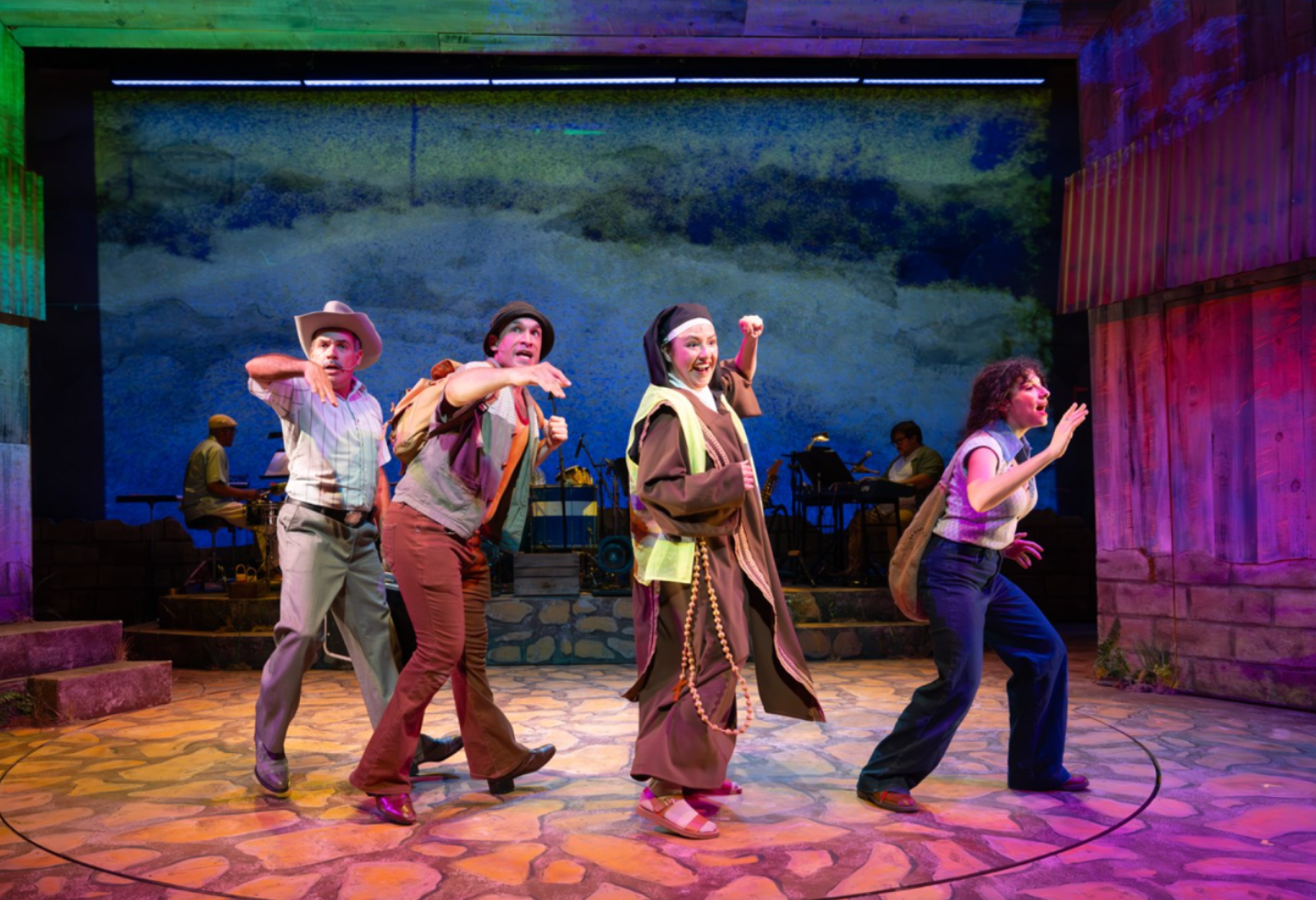 Ensemble cast in motion during Somewhere Over the Border